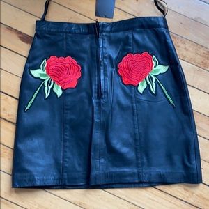 Black leather mini skirt with rose detail